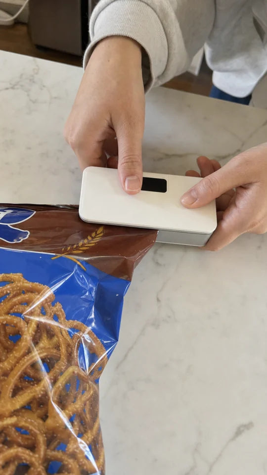 Customer sealing a snack bag with SealMate